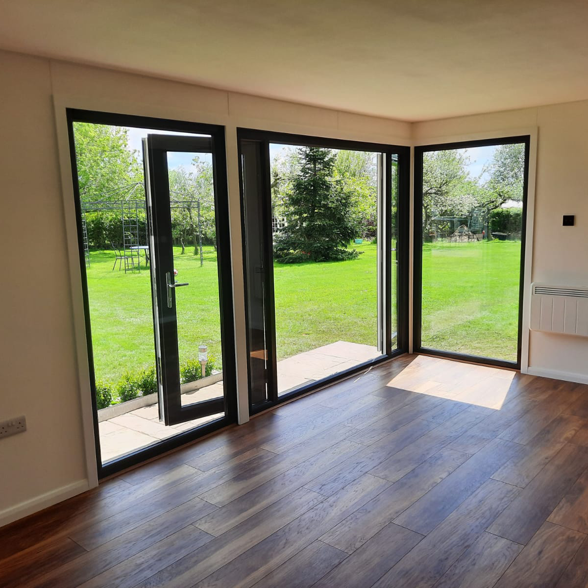 Inside garden room in garden with doors open